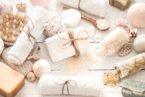 Spa composition of various objects for body care on a light wooden background, the concept of beauty and health